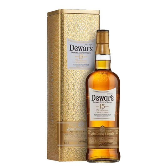 Garrafa Dewar's The Monarch 15 anos ao lado do estojo metálico dourado.
